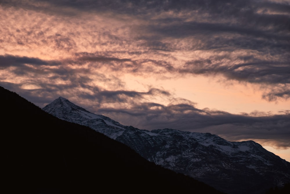 a view of a mountain with clouds in the sky