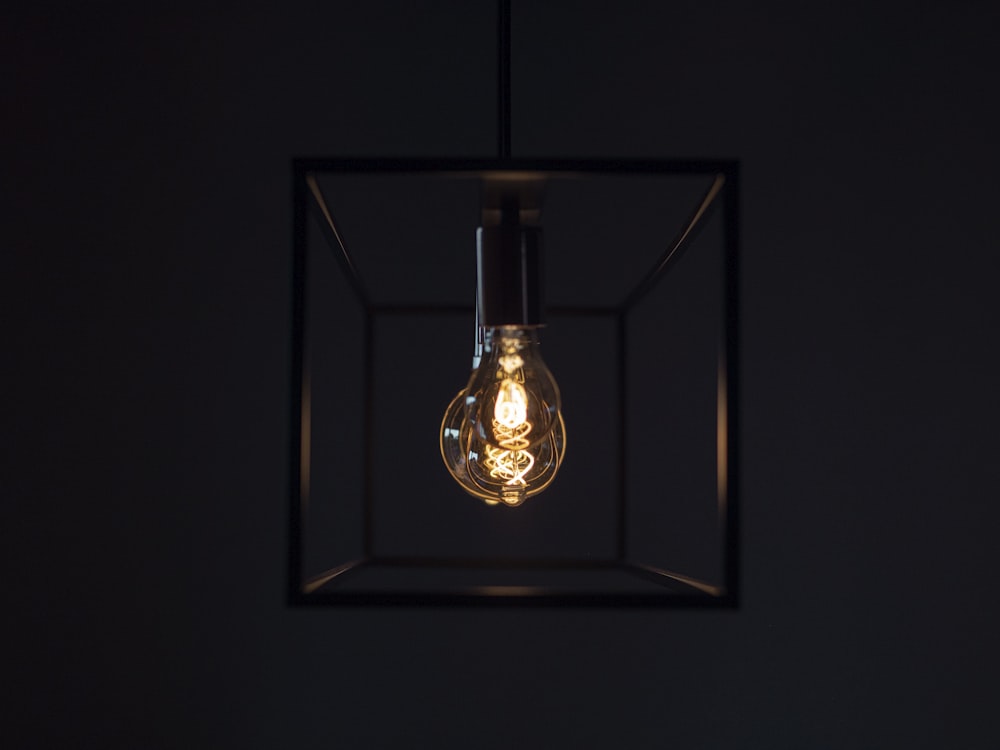 a light bulb hanging from the ceiling in a dark room