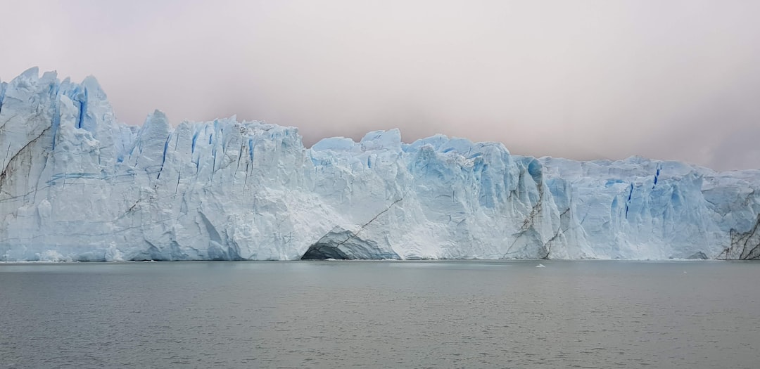 a large iceberg towering over a body of water, A large ice in Perito Moreno - Argentina!