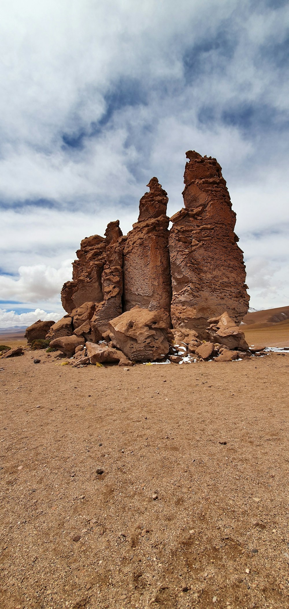 a large rock formation in the middle of a desert