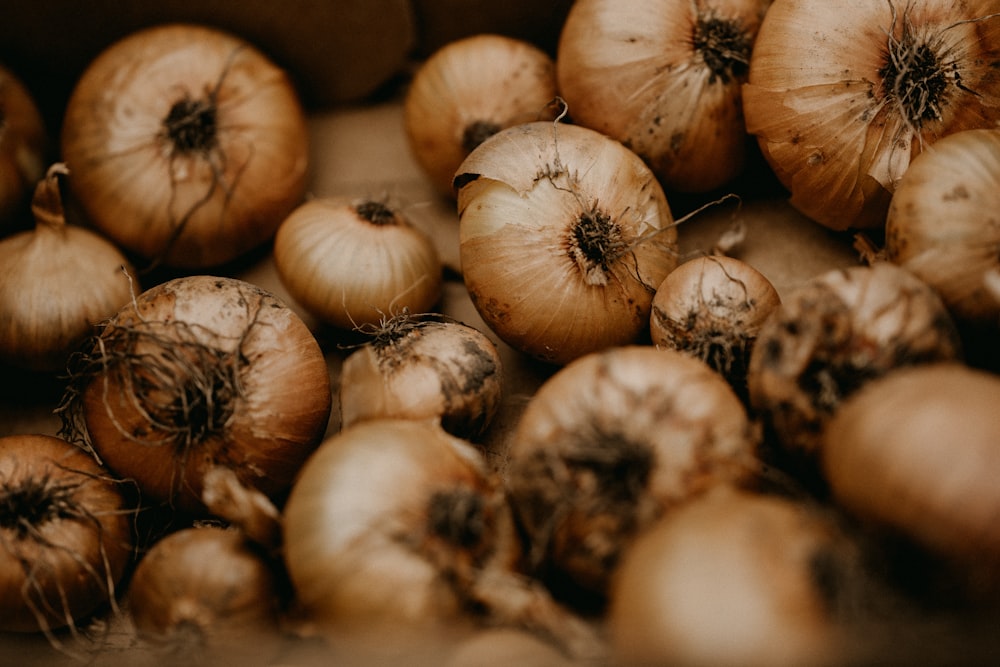 a pile of onions sitting on top of a table