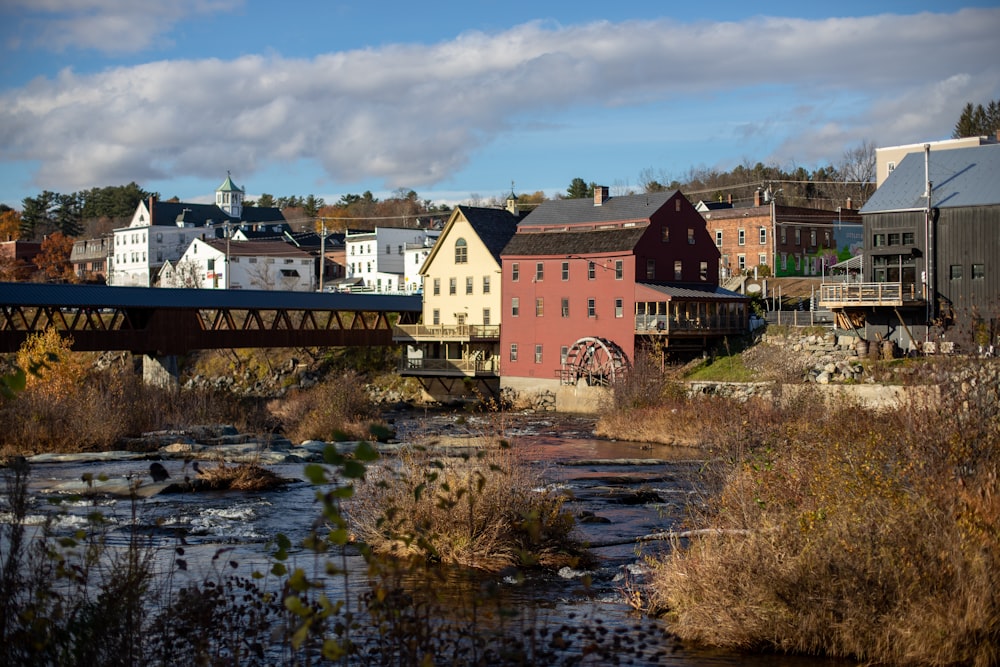 a river running through a small town next to a bridge