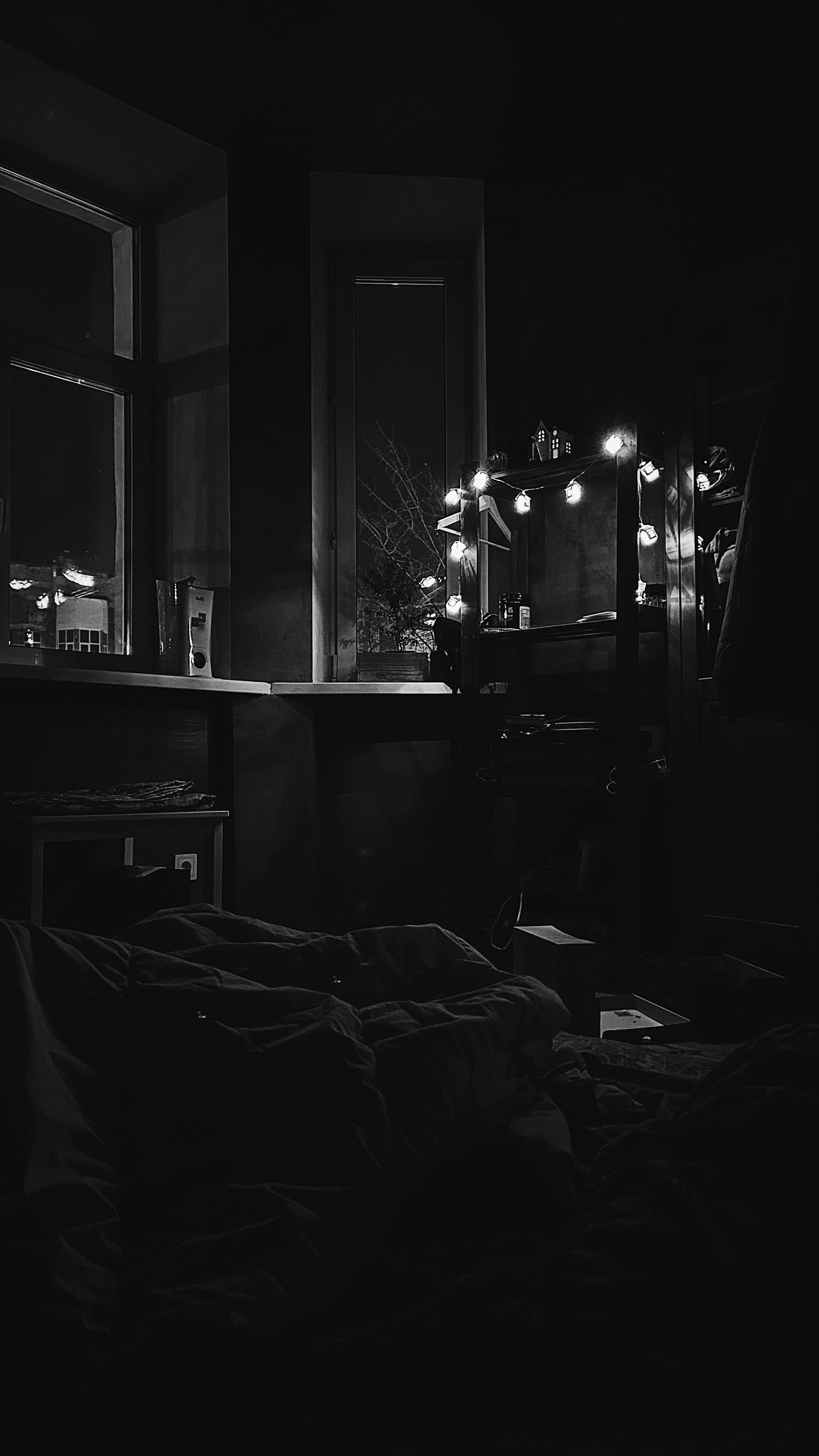 Dim bedroom with warm lamp glow, soft shadows, intimate quiet atmosphere