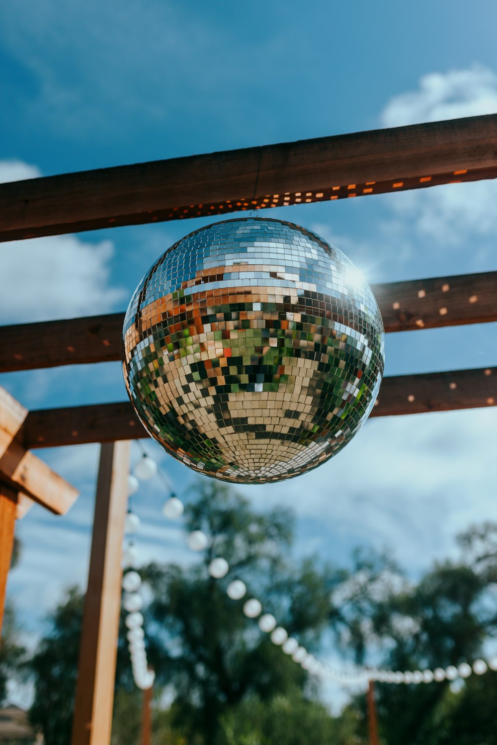 a disco ball hanging from a wooden structure
