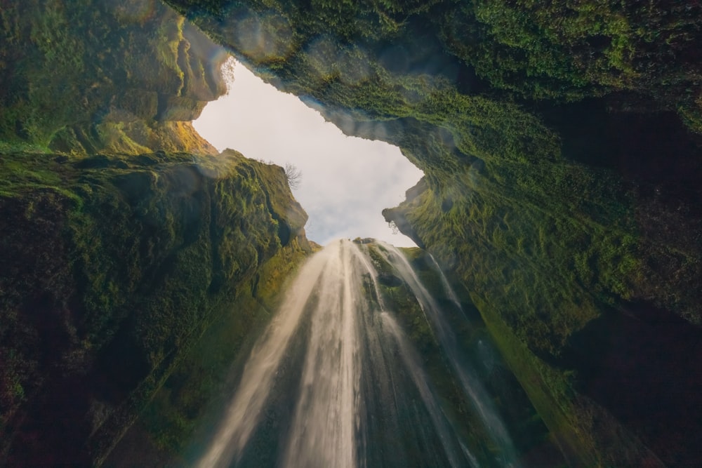 a waterfall with a hole in the middle of it