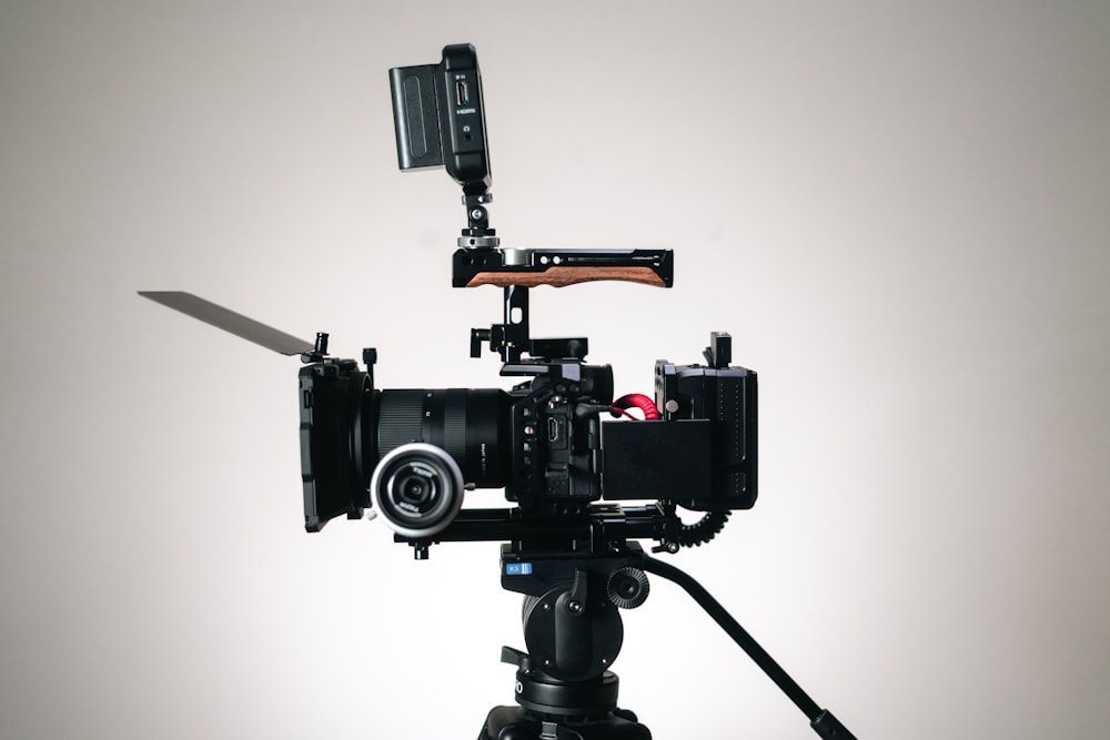 a video camera on a tripod on a white background