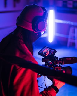 a person with headphones holding a video camera