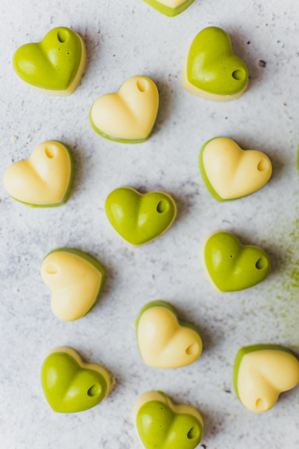 green and white heart shaped cookies on a table