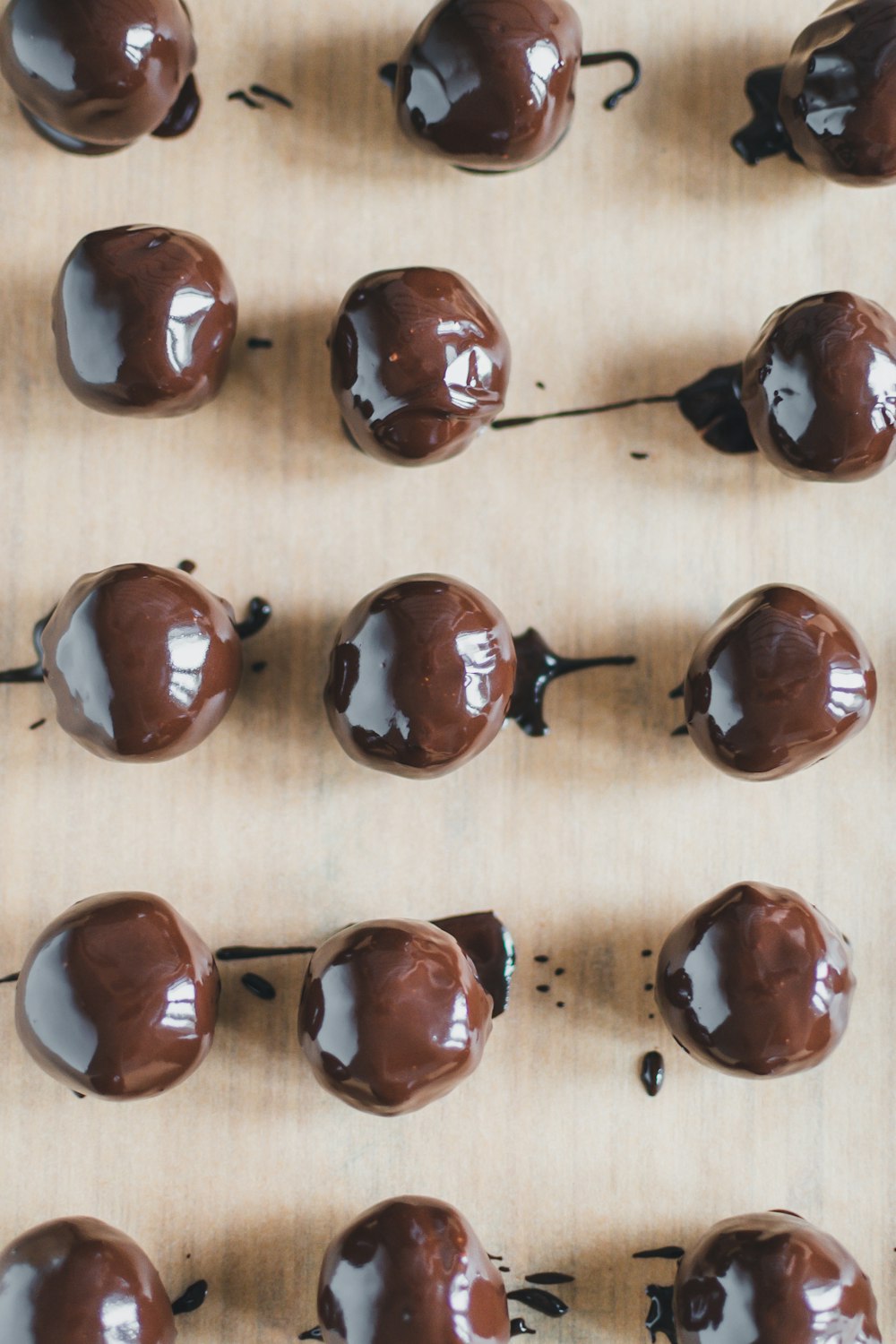 a tray of chocolate covered donuts on a table