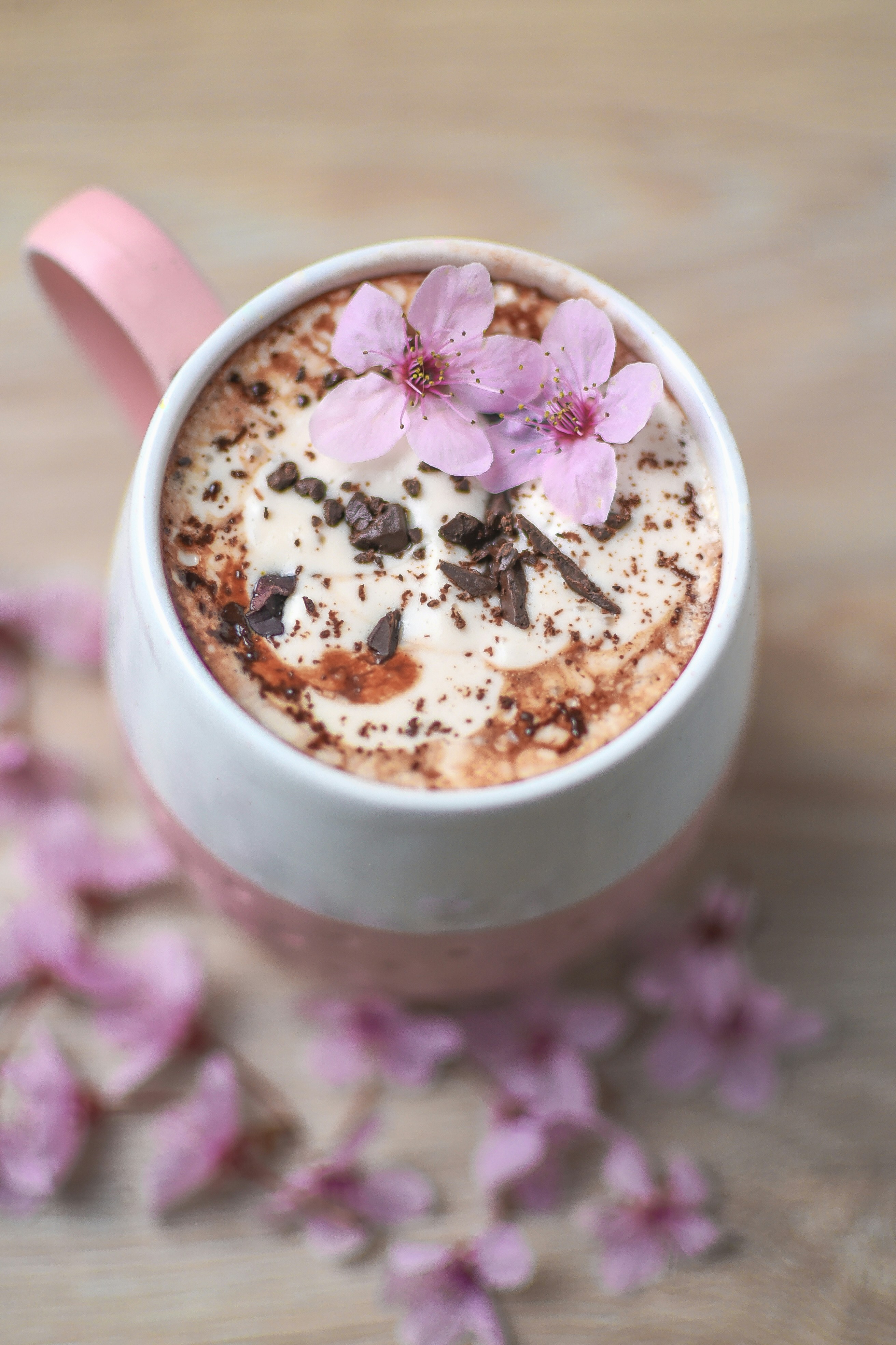 a cup of hot chocolate with flowers on top