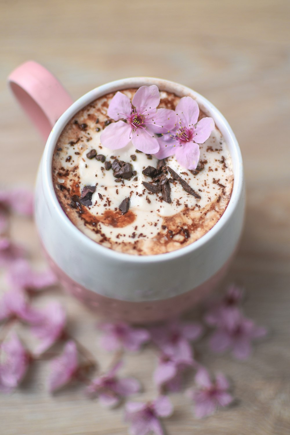 a cup of hot chocolate with flowers on top