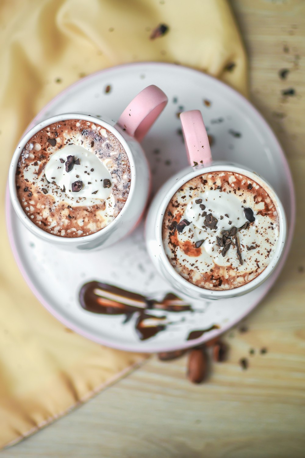 two cups of hot chocolate on a plate