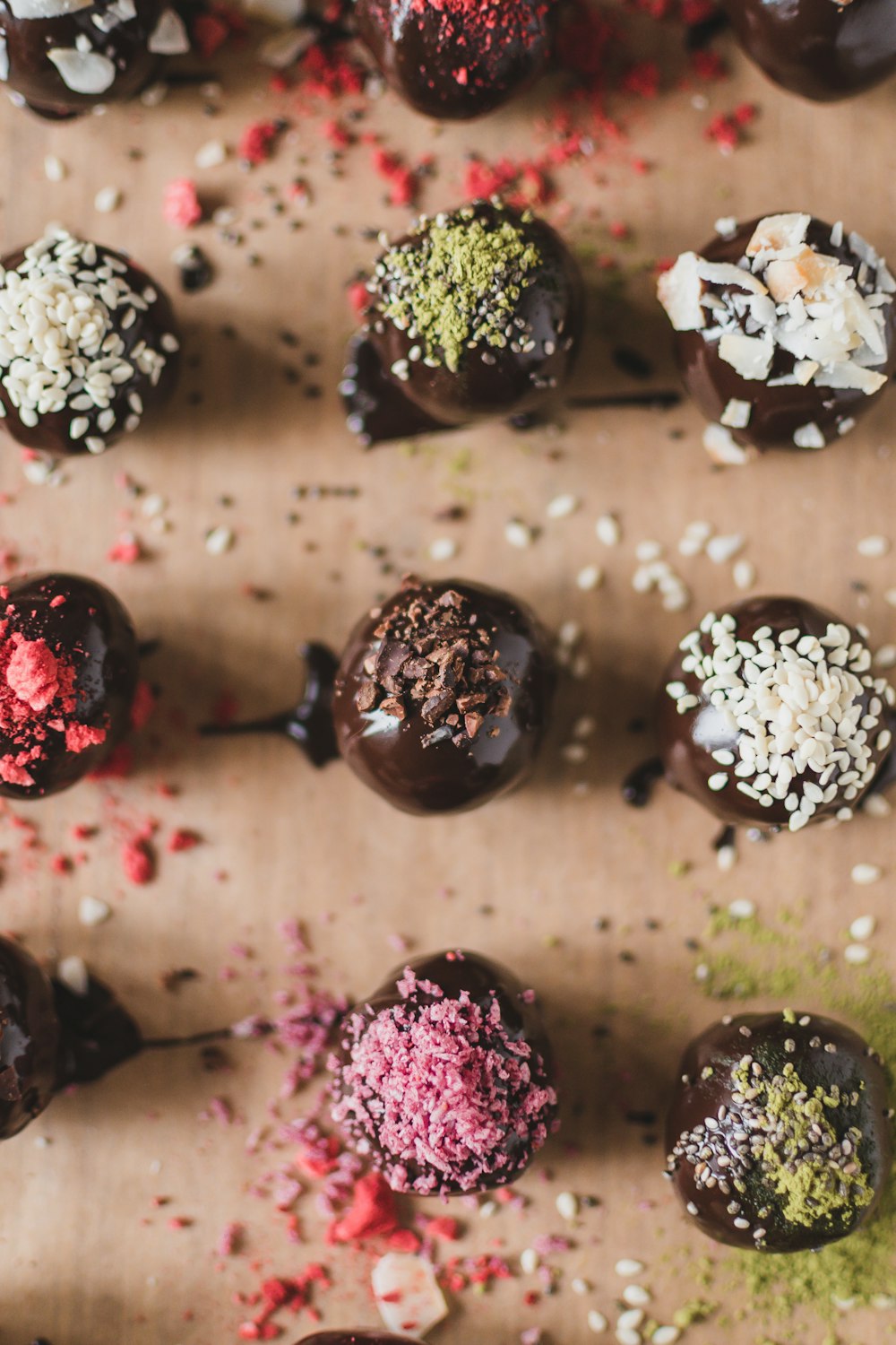 a table topped with chocolate covered donuts covered in sprinkles