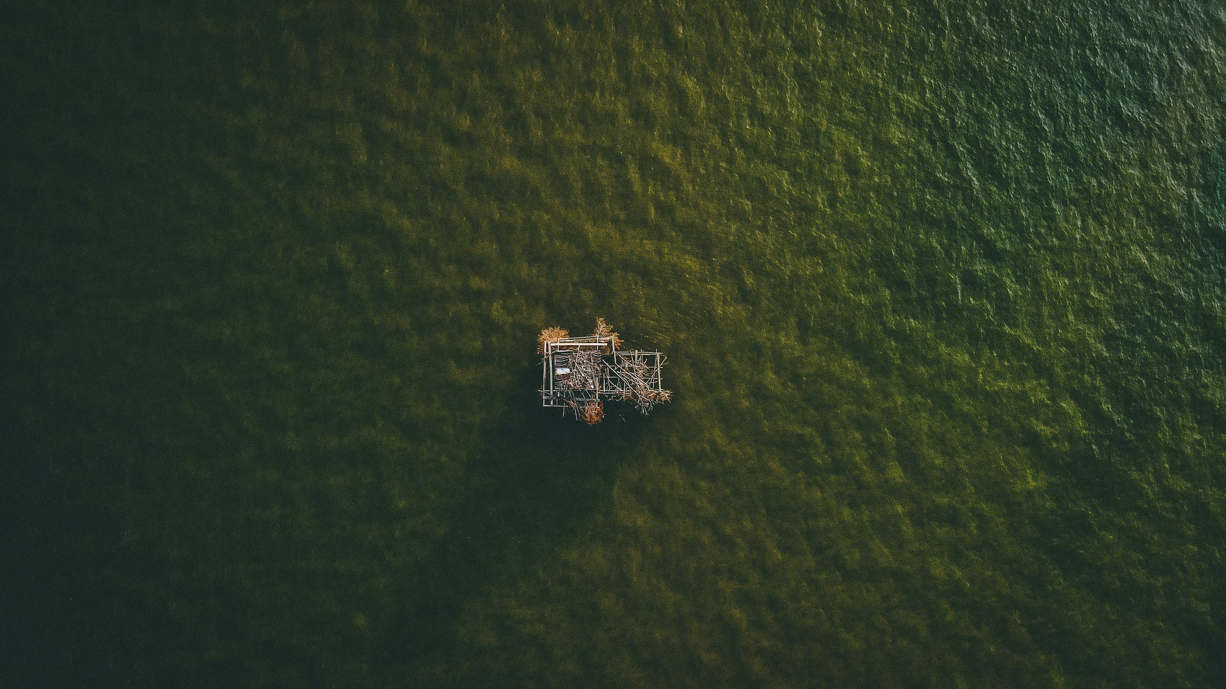 an aerial view of a boat in the water