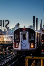 a train on a train track with a city in the background