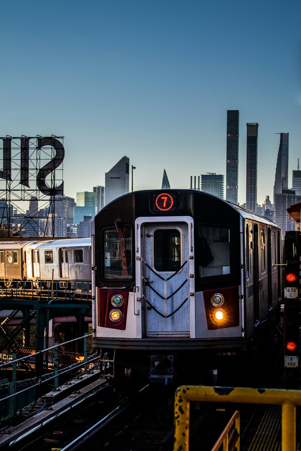 a train on a train track with a city in the background