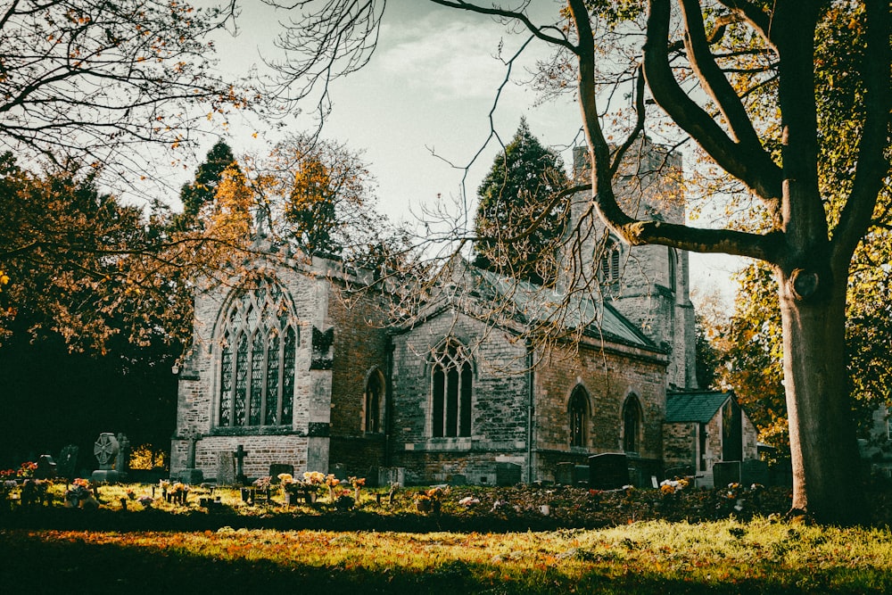 an old church with a graveyard in front of it