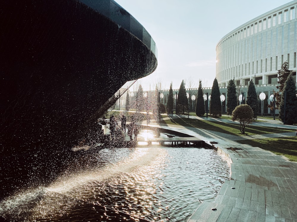 a water fountain in front of a large building