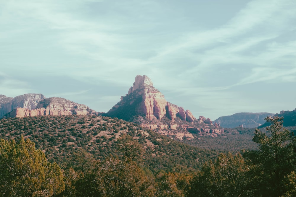 a mountain range with trees and mountains in the background