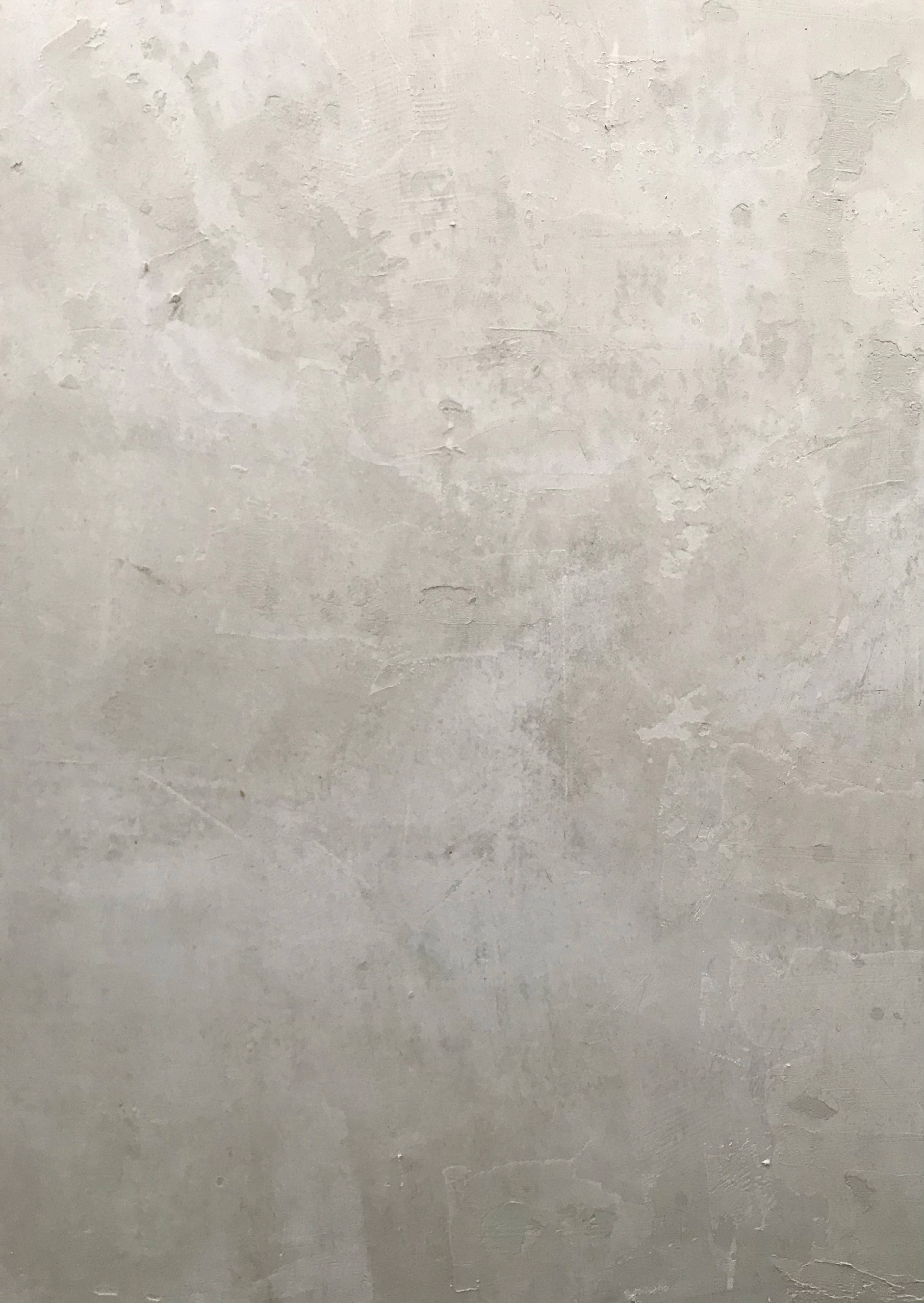 Pale mottled plaster wall with a chalky, matte finish