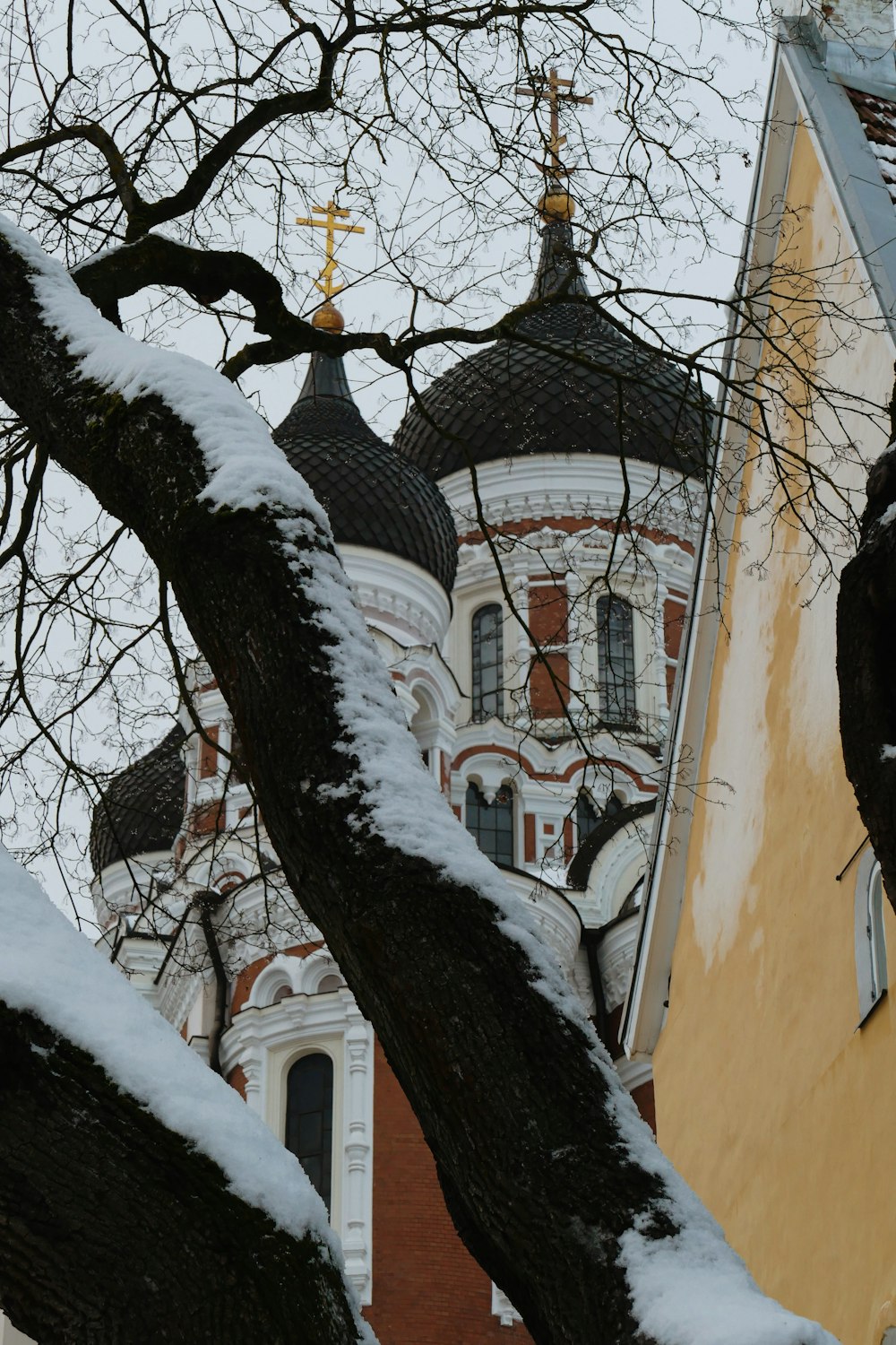 a church with a steeple covered in snow