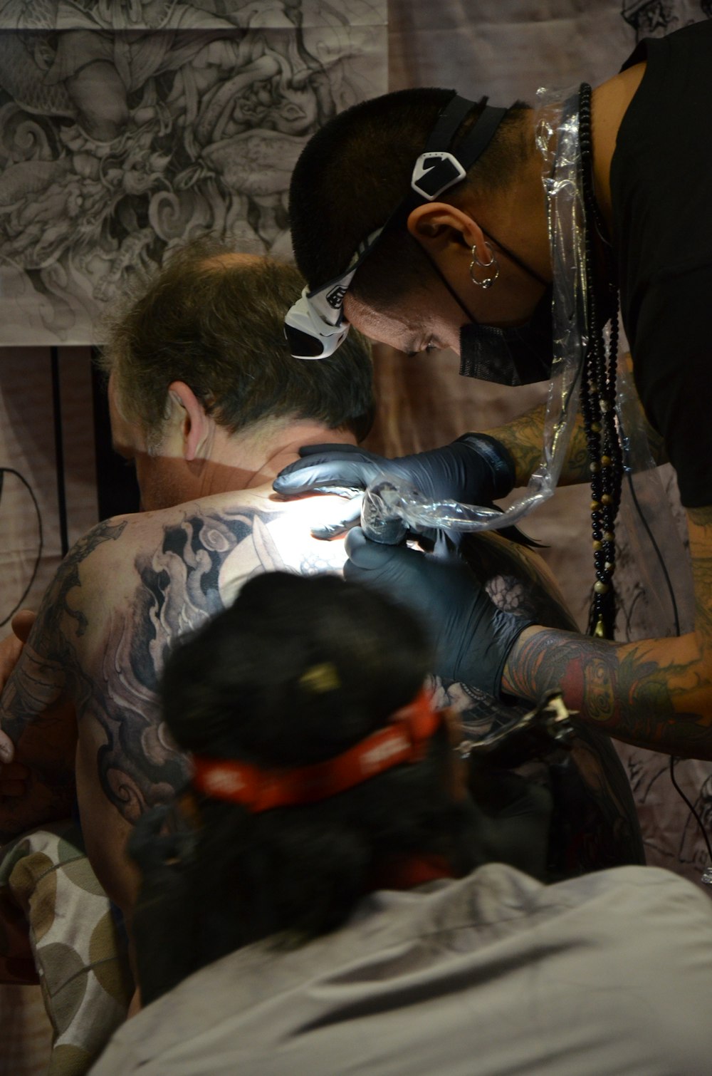 a man getting a tattoo on his chest