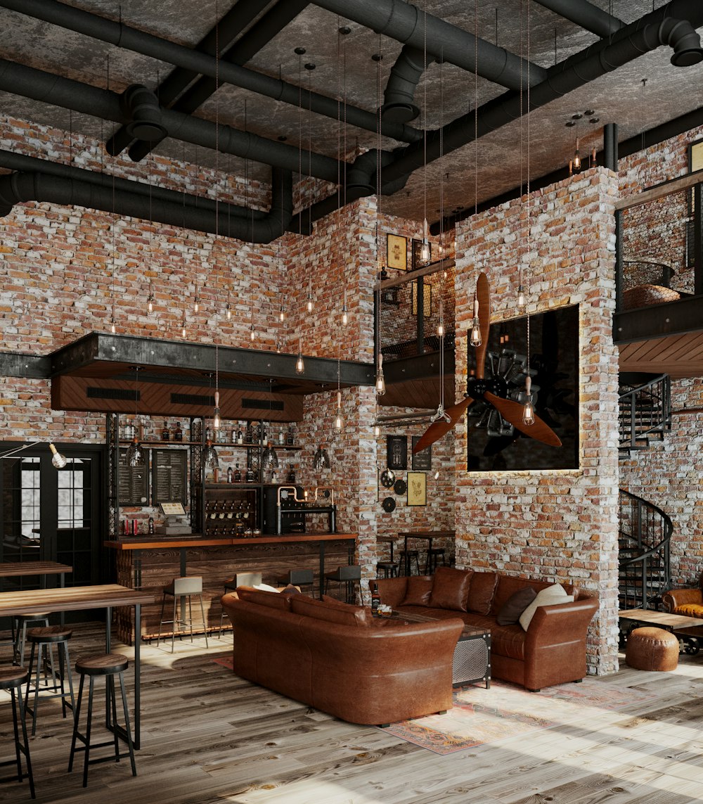 a living room filled with furniture and a brick wall