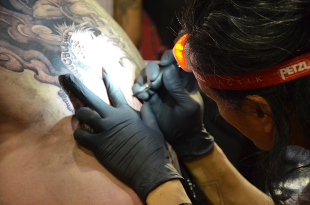 a man getting a tattoo on his arm