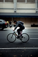 a man riding a bike in a parking lot
