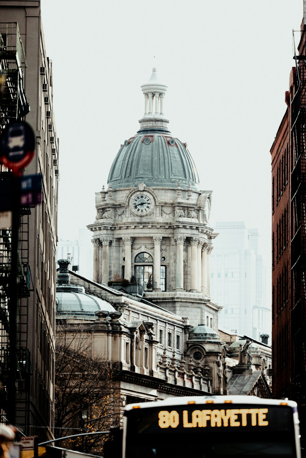 a city street with a bus parked in front of a building