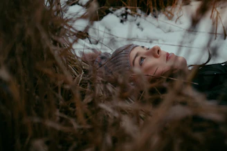 a woman is laying down in the snow