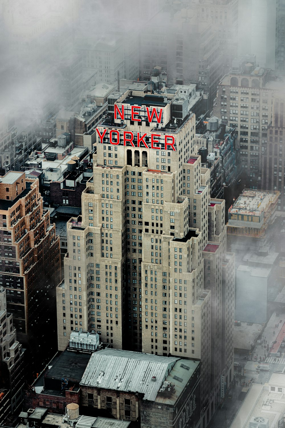 a very tall building with a neon sign on top of it