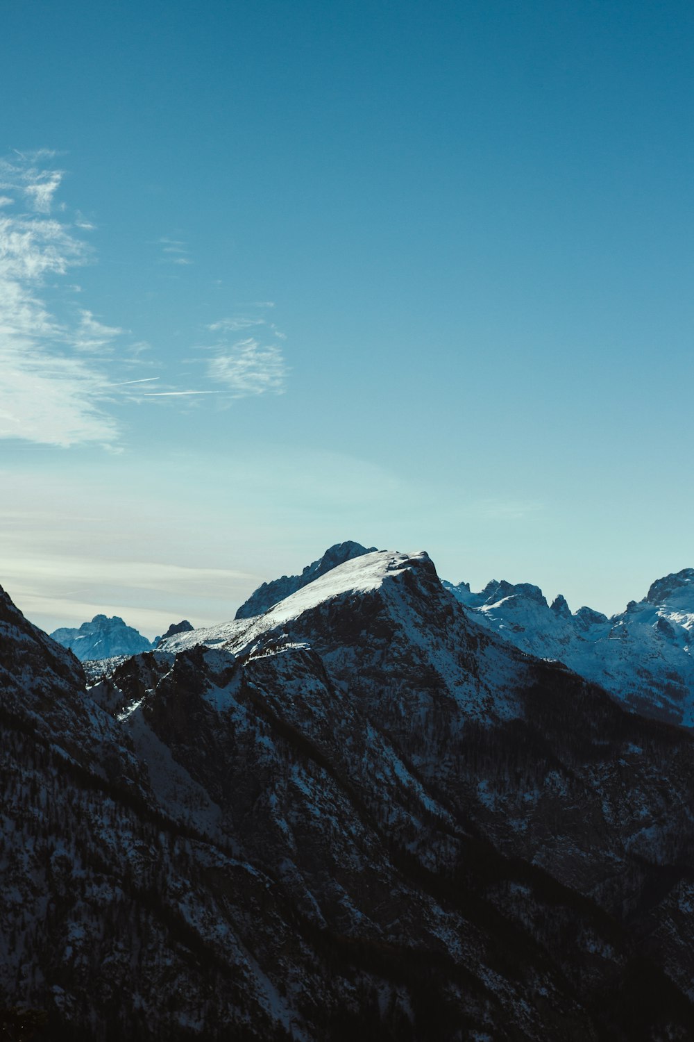 a view of the top of a mountain with a sky background