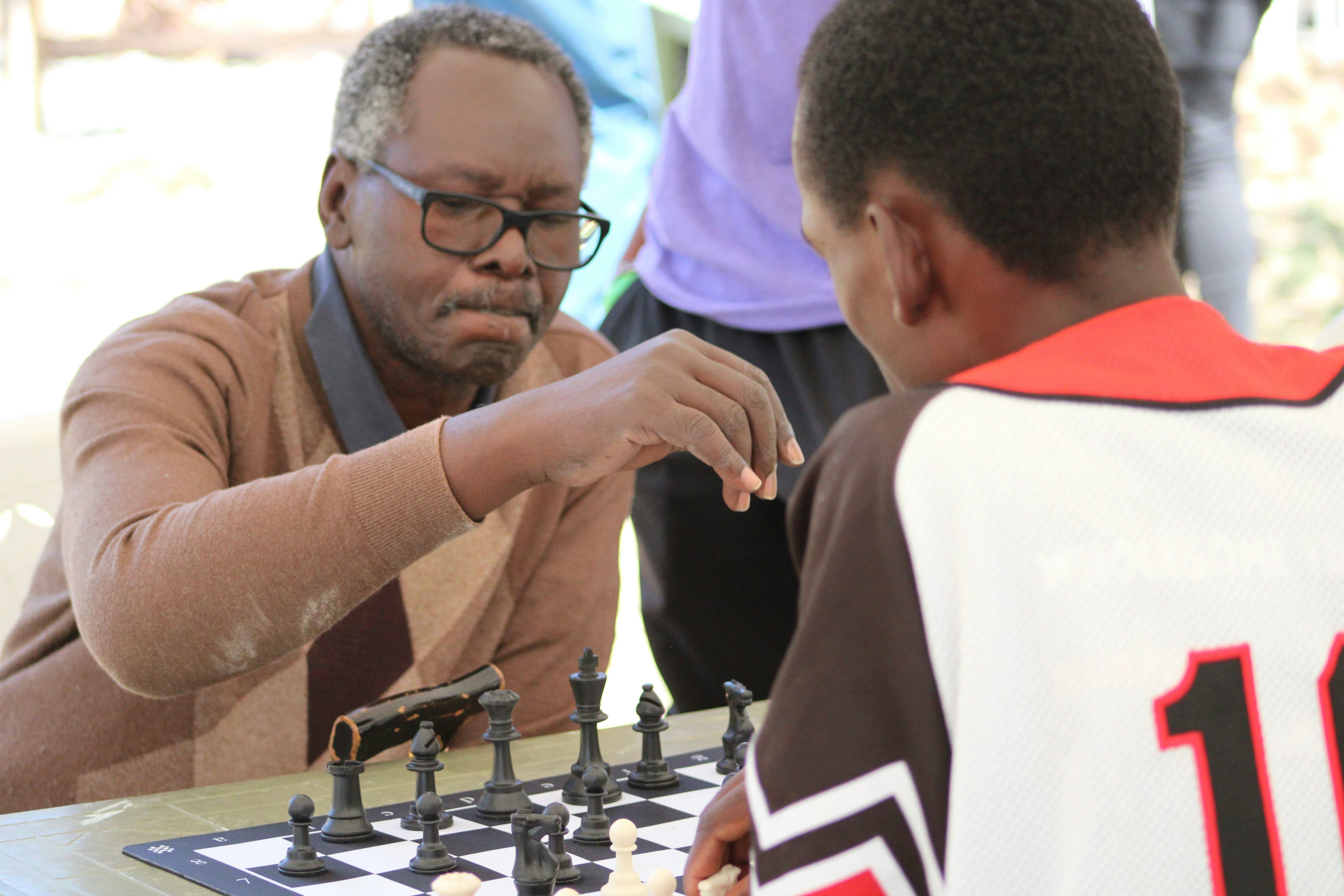 a man playing chess with a young boy