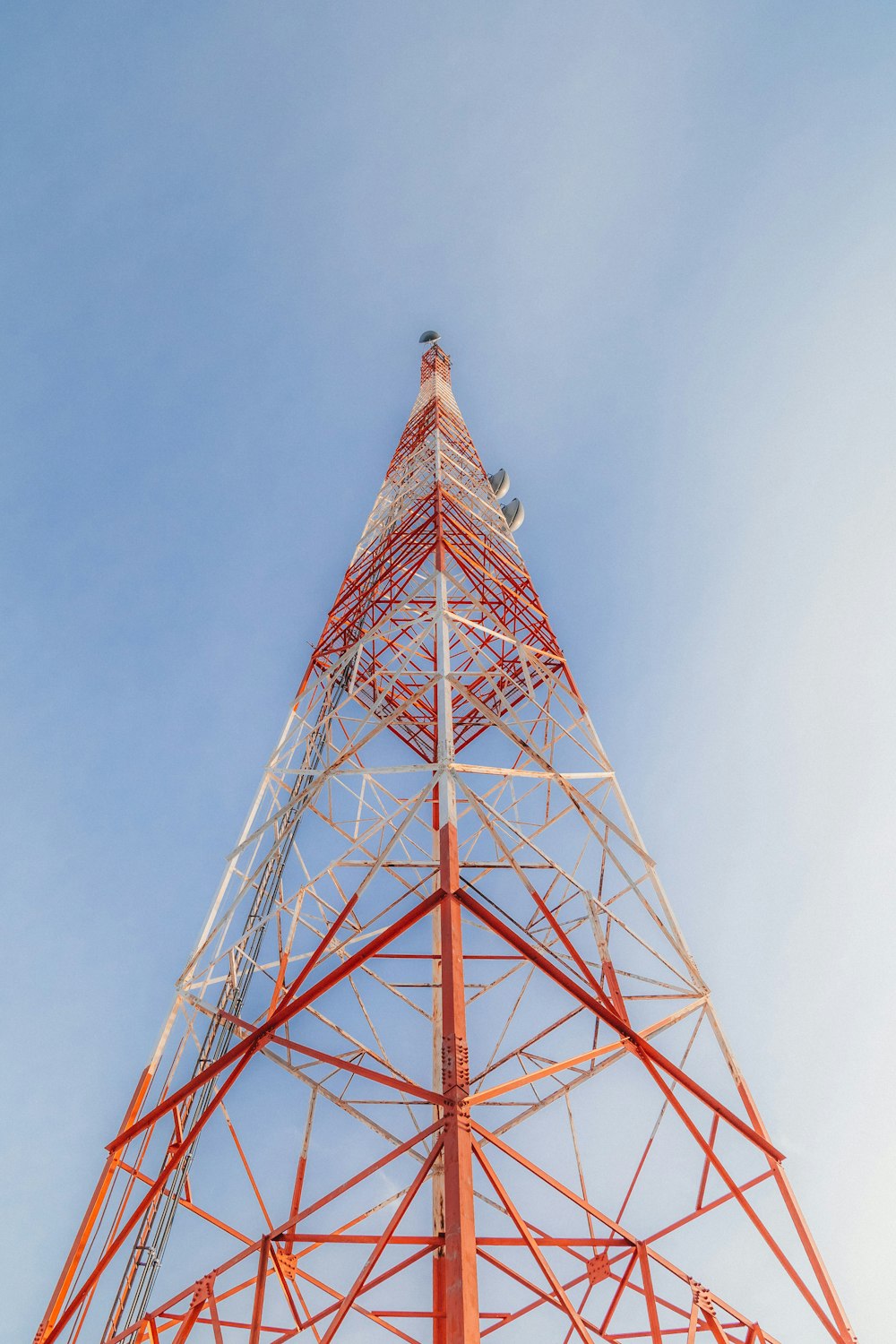 a tall red tower with a sky in the background