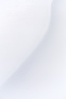 a man riding skis down a snow covered slope