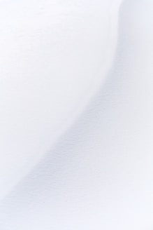 a man riding skis down a snow covered slope