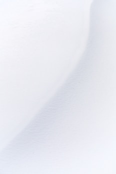 a man riding skis down a snow covered slope