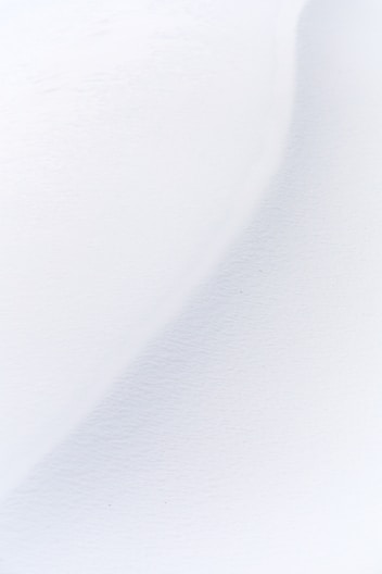 a man riding skis down a snow covered slope