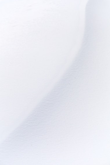 a man riding skis down a snow covered slope