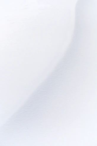 a man riding skis down a snow covered slope