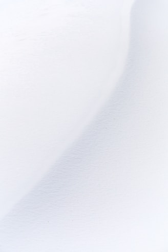 a man riding skis down a snow covered slope