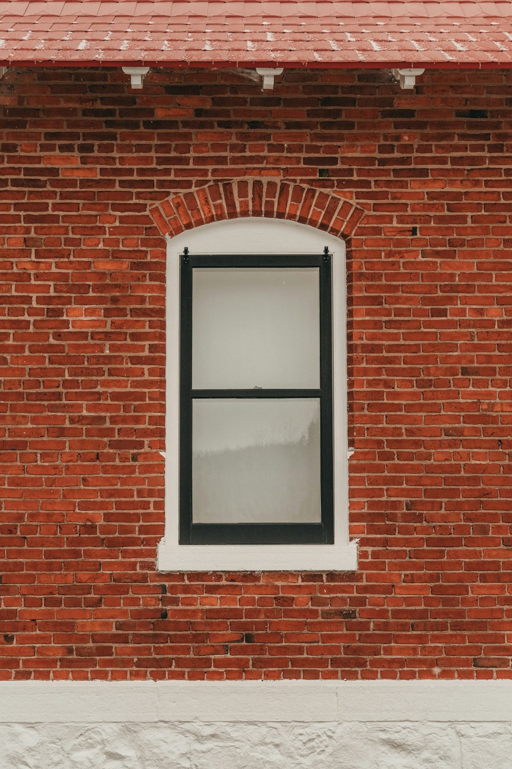 a red brick building with a white window