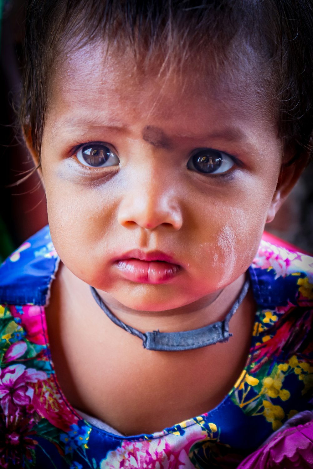 a close up of a child wearing a collar