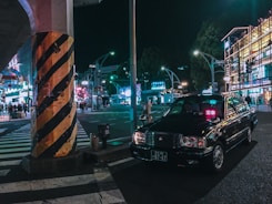 A taxi parked in a busy urban area.