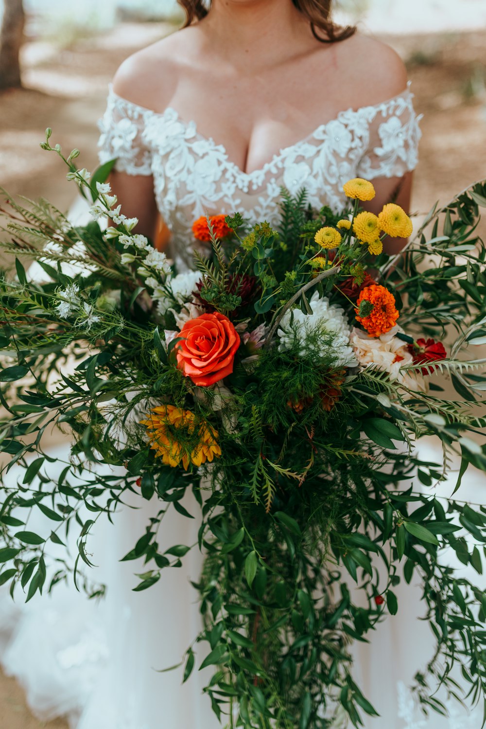 a woman in a wedding dress holding a bouquet of flowers