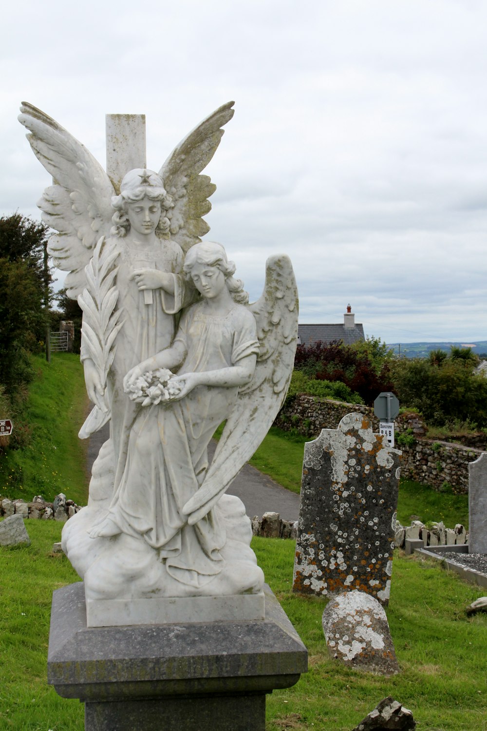 a statue of an angel holding a child