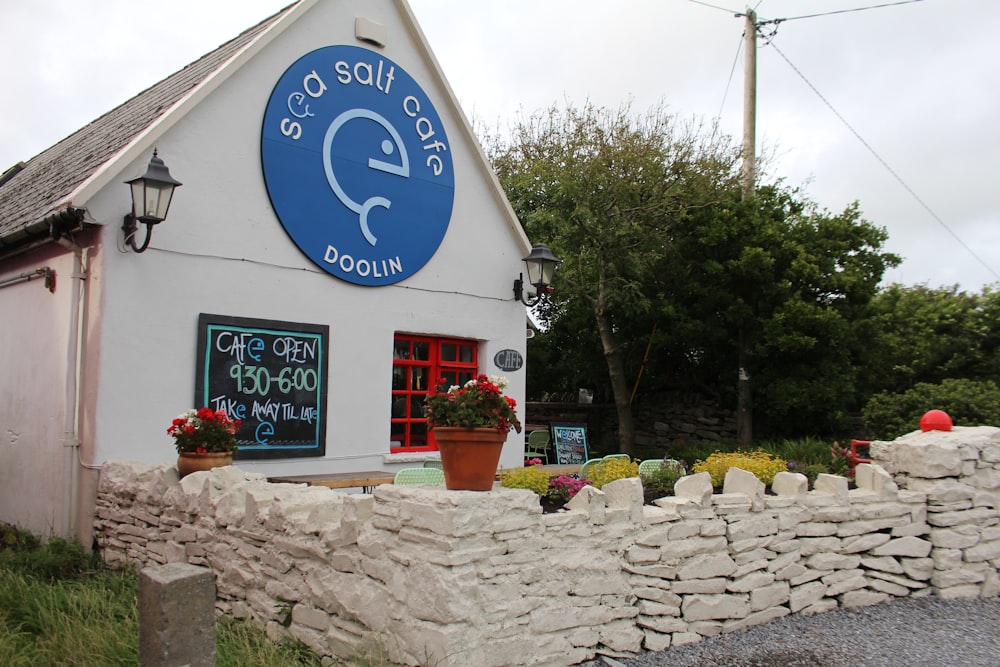 a white building with a blue sign on it