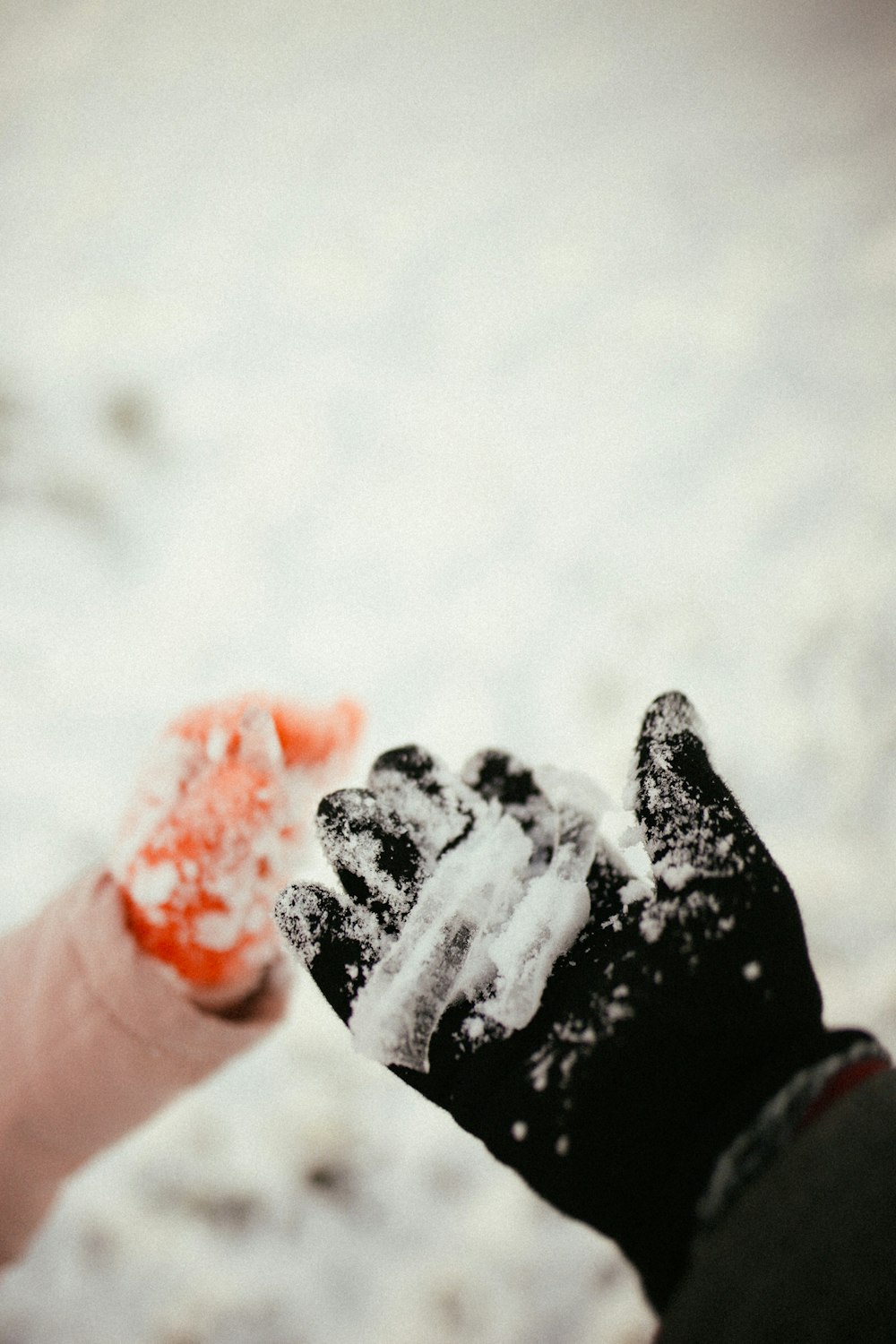 a person holding their hand out in the snow