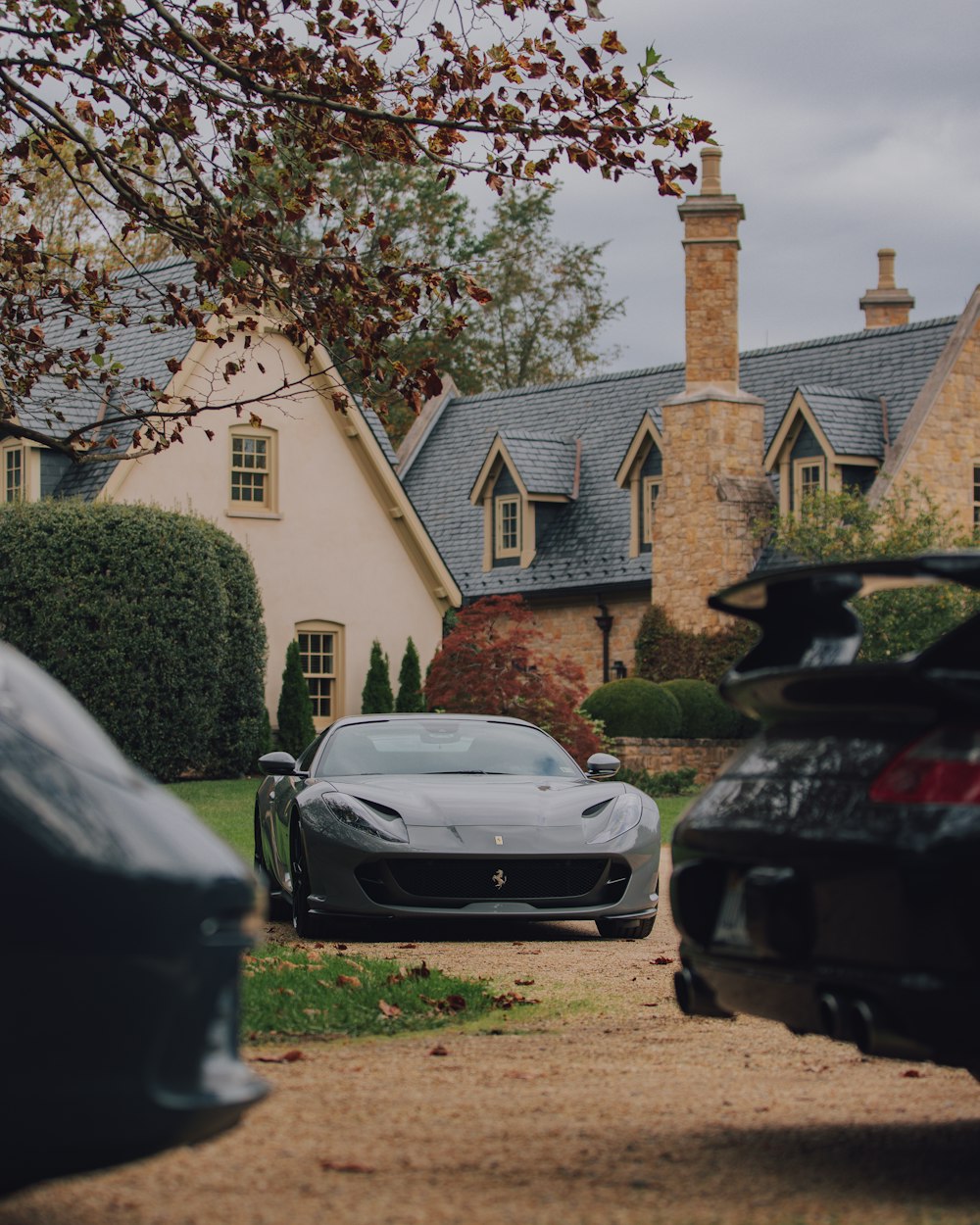 a black sports car parked in front of a house